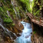 Roaring masses of water in the narrow Wimbachklamm with a wooden path